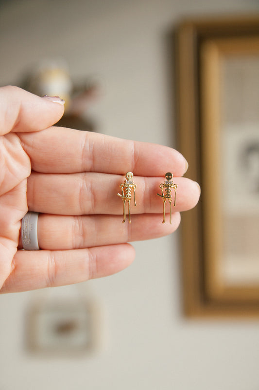 Drop Dead Skeleton Earrings - Gold